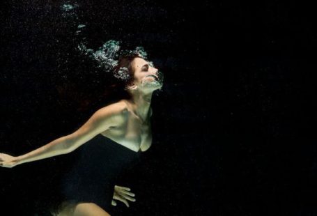Drift Diving - Woman Wearing Black Dress Under Water Photography
