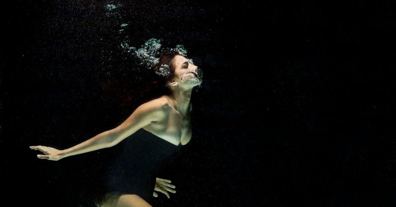 Drift Diving - Woman Wearing Black Dress Under Water Photography