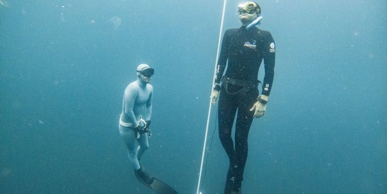 Freediving Fins - Breath-holding Diver Emerging Under the Supervision of Another Freediver