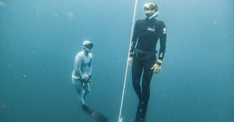 Freediving Fins - Breath-holding Diver Emerging Under the Supervision of Another Freediver