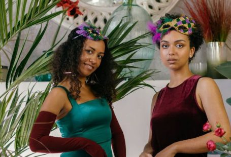 Masks Glasses - Photo of Women in Dresses Posing Near a Table