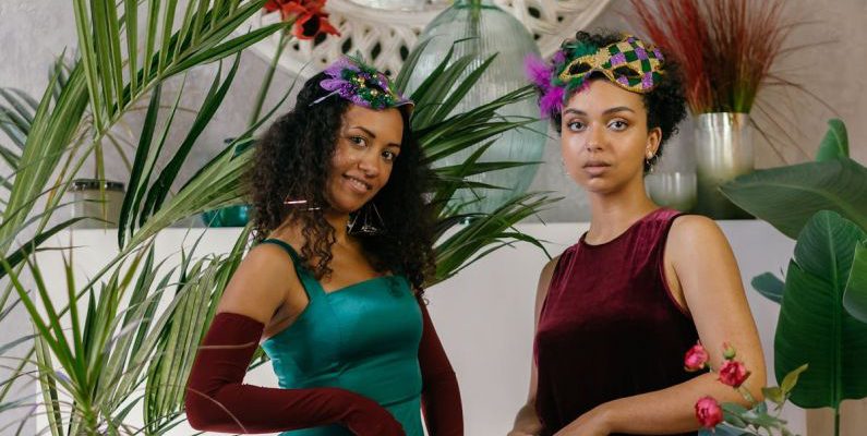 Masks Glasses - Photo of Women in Dresses Posing Near a Table