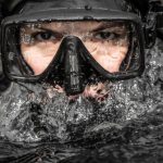 Galapagos Diving - A man wearing a scuba mask and goggles in the water