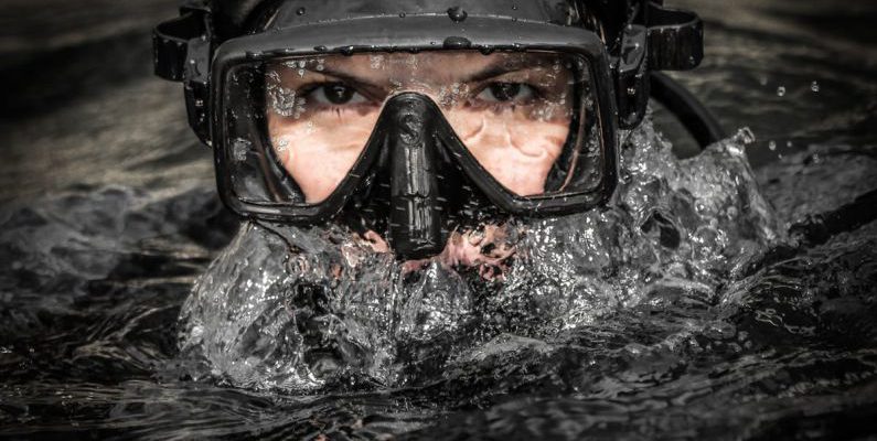 Galapagos Diving - A man wearing a scuba mask and goggles in the water