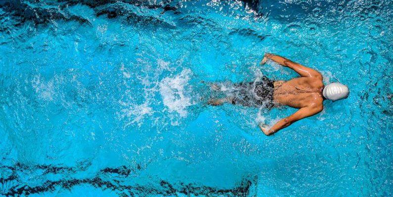Buoyancy Diving - Person Swimming on Body of Water