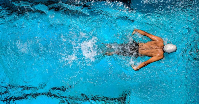Buoyancy Diving - Person Swimming on Body of Water