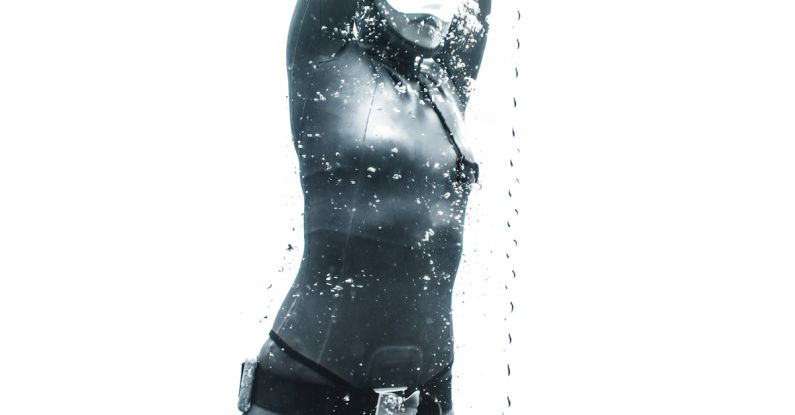 Ascend Diving - Low angle of anonymous female diver wearing swimsuit and snorkeling mask and diving under clear water near rope among air bubbles