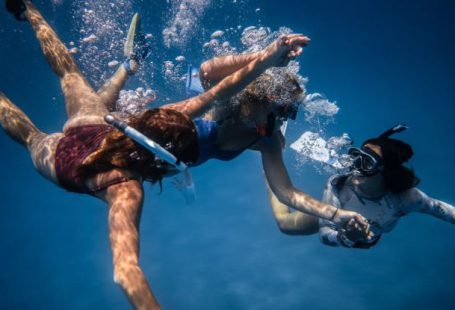 Underwater Communication - Group of young people with special equipment enjoying time together underwater with bubbles of oxygen