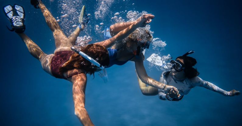 Underwater Communication - Group of young people with special equipment enjoying time together underwater with bubbles of oxygen