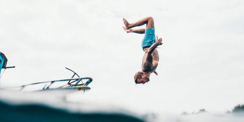 Rescue Diving - Man Wearing Blue Shorts About to Dive on Body of Water