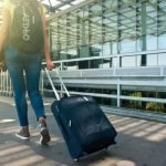 Packing Diving - Woman Walking on Pathway While Strolling Luggage