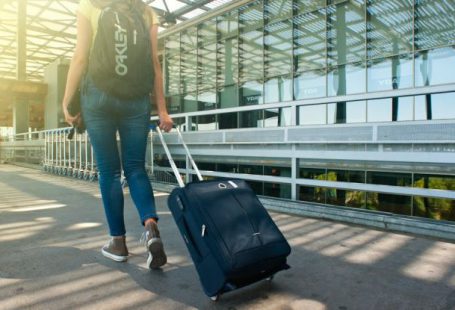 Packing Diving - Woman Walking on Pathway While Strolling Luggage