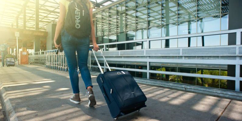 Packing Diving - Woman Walking on Pathway While Strolling Luggage