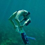 Bonaire Diving - A person swimming in the ocean with a snorkel