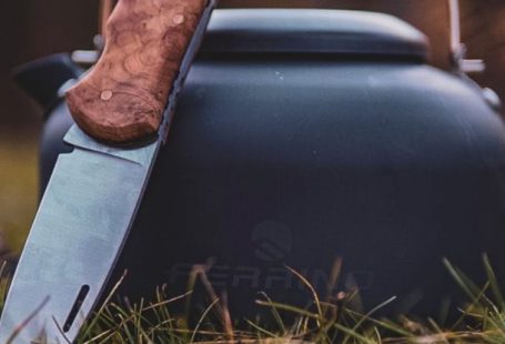 Renting Gear - A knife and a kettle sitting on the grass