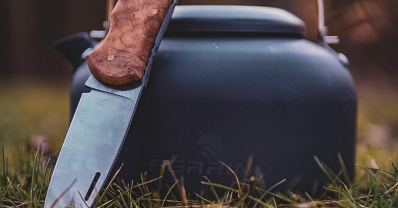 Renting Gear - A knife and a kettle sitting on the grass
