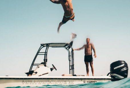 First Dive - Photo of Man Jumping from Boat to the Sea
