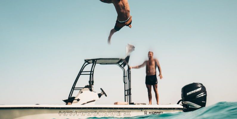 First Dive - Photo of Man Jumping from Boat to the Sea