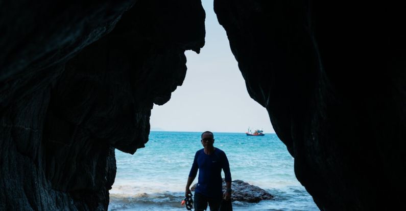 Cave Diving - Man in Diving Suit Standing on Beach